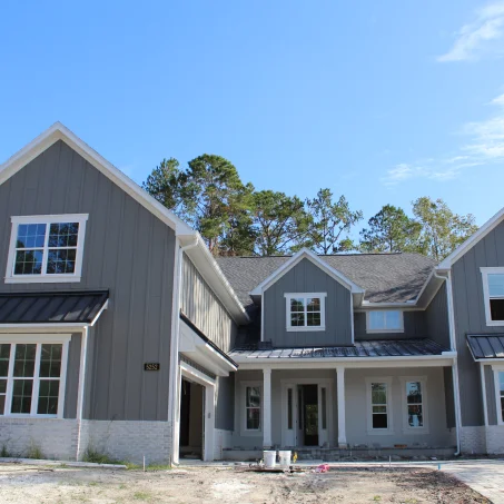 Image of a house under the name "The Lombardy" with an exterior view and floor plan. Includes details of square footage, room types, and contact information for Brian Designs and Habri Builders.